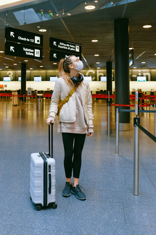 woman wearing face mask at airport